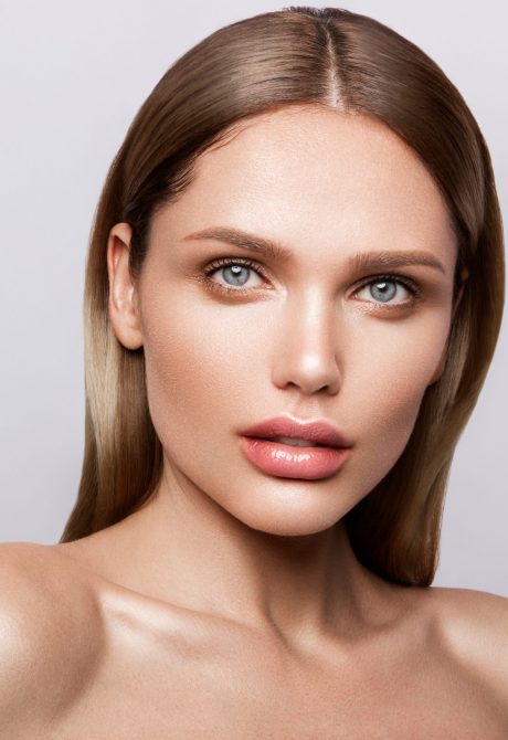 Beauty portrait of model with natural make-up Beauty portrait of model with natural make-up. Fashion shiny highlighter on skin, sexy gloss lips make-up